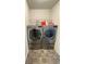 Convenient laundry room featuring modern front-loading washer and dryer units and tiled flooring at 1603 Maston Rd, Auburn, GA 30011