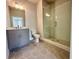 Bathroom with a gray vanity, a shower and hexagon tile flooring at 169 Ward