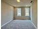 A bedroom offers carpet, two windows for ample light and neutral color at 169 Ward