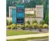 View of the community entrance, with signage, landscaping, and starting prices displayed at 169 Ward