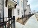 Inviting townhome entrance with stylish accents, black fencing, and meticulous landscaping at 169 Ward