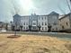 Exterior view of brick townhomes with tidy lawns and landscaping features at 169 Ward