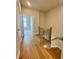 Hallway view of stairs and hallway with hardwood floors and light filled open bedroom at 169 Ward