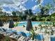 Community pool area with lounge chairs, umbrellas, and mature shade trees at 169 Ward