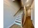 Staircase with hardwood floors and natural wood railing at 169 Ward