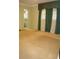 Spacious bedroom features carpeted floors, green walls, and bathroom access at 3204 Spreading Oak Sw Dr, Atlanta, GA 30311