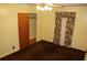 Bedroom with brown carpeting, window with curtains and a ceiling light fixture at 3204 Spreading Oak Sw Dr, Atlanta, GA 30311