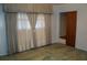 Bedroom with green carpeting, window with curtains and a closet at 3204 Spreading Oak Sw Dr, Atlanta, GA 30311