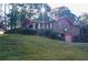 Well-maintained brick home with a front porch and mature landscaping at 3204 Spreading Oak Sw Dr, Atlanta, GA 30311