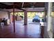 Spacious garage with red floors leading out to the driveway and front yard at 3204 Spreading Oak Sw Dr, Atlanta, GA 30311