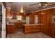 Wood-paneled kitchen featuring wood cabinets and a bar with shelving at 3204 Spreading Oak Sw Dr, Atlanta, GA 30311