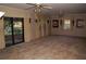 Large living room with two ceiling fans and sliding glass doors leading to the outside at 3204 Spreading Oak Sw Dr, Atlanta, GA 30311