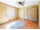 Bedroom with hardwood floors and a large window and closet at 4031 Pine Needle Dr, Duluth, GA 30096