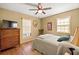 Comfortable bedroom featuring wood floors, a ceiling fan, and natural light at 4031 Pine Needle Dr, Duluth, GA 30096