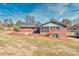 Exterior of brick home with a sunroom and back yard at 4031 Pine Needle Dr, Duluth, GA 30096