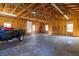 Large, unfinished garage interior with natural light, exposed trusses and a trailer at 4031 Pine Needle Dr, Duluth, GA 30096