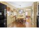 Eat-in kitchen features tan cabinets, black refrigerator, and wood table and chairs at 4031 Pine Needle Dr, Duluth, GA 30096