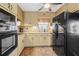 Kitchen featuring tan cabinetry, stainless appliances, and eat-in dining area at 4031 Pine Needle Dr, Duluth, GA 30096