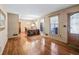 Open-concept living space with hardwood floors connecting to the dining area at 4031 Pine Needle Dr, Duluth, GA 30096