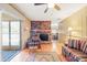 Living room featuring a fireplace, wood floors, and a sliding glass door at 4031 Pine Needle Dr, Duluth, GA 30096