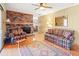 Living room featuring a fireplace, wood floors, and plenty of seating at 4031 Pine Needle Dr, Duluth, GA 30096