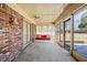 Enclosed sunroom with brick wall and several windows offering natural light at 4031 Pine Needle Dr, Duluth, GA 30096