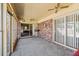 Enclosed sunroom with carpet flooring, ceiling fans, and brick wall at 4031 Pine Needle Dr, Duluth, GA 30096