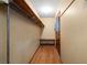 A walk-in closet with wooden floors, wire shelving, and bench at 4031 Pine Needle Dr, Duluth, GA 30096