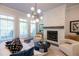 Bright living room featuring a brick fireplace, comfortable seating, and a large window for natural light at 606 Goldsmith Ct # 114, Johns Creek, GA 30022