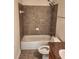 Elegant bathroom featuring a tiled shower, granite countertop, and sleek fixtures at 2823 Mount Wilkinson Se Pkwy # 14, Atlanta, GA 30339
