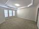 Bright, carpeted bedroom with tray ceilings and plantation shutters for a cozy retreat at 2823 Mount Wilkinson Se Pkwy # 14, Atlanta, GA 30339