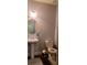 Elegant half bath with a pedestal sink, round mirror, and modern toilet at 5008 Whiteoak Pointe Se # 15, Smyrna, GA 30080