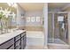 Well-lit bathroom featuring double vanity, tub, and glass enclosed shower at 5008 Whiteoak Pointe Se # 15, Smyrna, GA 30080