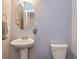 Powder room featuring a pedestal sink, oval mirror, and neutral color scheme at 5008 Whiteoak Pointe Se # 15, Smyrna, GA 30080