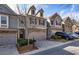 Two-story townhouse with a brick-and-siding facade, two-car garage, and neat landscaping at 5008 Whiteoak Pointe Se # 15, Smyrna, GA 30080