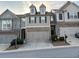 Traditional two-story townhouse featuring a two-car garage and manicured landscaping at 5008 Whiteoak Pointe Se # 15, Smyrna, GA 30080