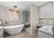 Modern bathroom featuring a soaking tub, glass-enclosed shower, and vanity area with marble countertops at 750 Park Ne Ave # 25W, Atlanta, GA 30326