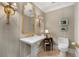 Stylish powder room with beautiful lighting fixtures, an elegant mirror and sink at 750 Park Ne Ave # 25W, Atlanta, GA 30326