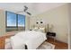 Bright bedroom showcasing a large window with a view, plush bedding, and a ceiling fan at 750 Park Ne Ave # 25W, Atlanta, GA 30326