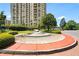 Beautiful building exterior featuring mature trees, manicured lawns, and an inviting fountain at 750 Park Ne Ave # 25W, Atlanta, GA 30326