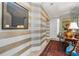 Elegant hallway featuring striped walls, mirrored accents, and a stylish rug at 750 Park Ne Ave # 25W, Atlanta, GA 30326