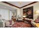 Comfortable living room with tasteful decor, rich wood floors, and a glimpse into other rooms at 750 Park Ne Ave # 25W, Atlanta, GA 30326