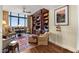 Comfortable living room showcasing a built-in bookcase, city views, and cozy seating arrangements at 750 Park Ne Ave # 25W, Atlanta, GA 30326