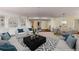 Bright living room with built-in shelving, comfortable seating, and open layout to dining area at 750 Park Ne Ave # 25W, Atlanta, GA 30326
