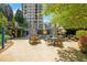 Outdoor pool area featuring tables, chairs, umbrellas, and lounge chairs at 750 Park Ne Ave # 25W, Atlanta, GA 30326