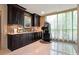 Stylish wet bar with dark cabinetry, marble countertop, and a convenient coffee machine at 750 Park Ne Ave # 25W, Atlanta, GA 30326