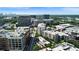 An aerial view showing apartments, tree lined streets, city buildings, and parking in a vibrant urban neighborhood at 1100 Howell Mill Nw Rd # 708, Atlanta, GA 30318