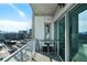 Balcony with glass railings, outdoor dining, and expansive city views at 1100 Howell Mill Nw Rd # 708, Atlanta, GA 30318