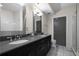 A modern bathroom with double sinks, a dark vanity, and white subway tile in the shower at 1100 Howell Mill Nw Rd # 708, Atlanta, GA 30318