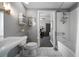 Stylish bathroom featuring a pedestal sink, subway tiles, and an open door to the living room at 1100 Howell Mill Nw Rd # 708, Atlanta, GA 30318